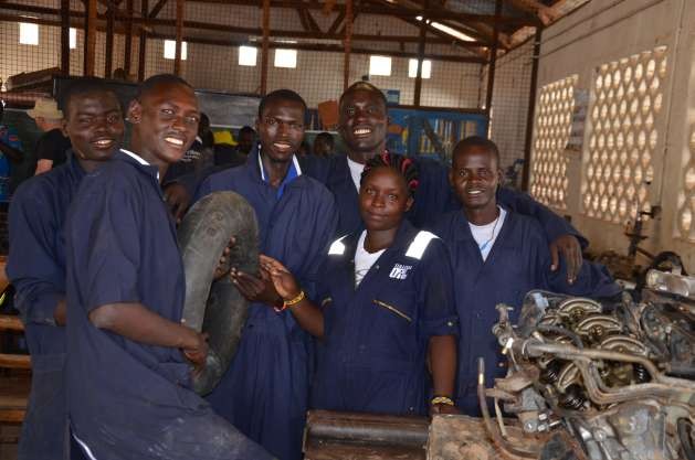 A lady mechanic student poses with male classmates during a practical session at the Lodwar Vocational Training Centre in Turkana County, Kenya. With empowerment, more women are making the decision to take up jobs and careers previously believed to be preserves of men. Photo courtesy of UN RCO Kenya.