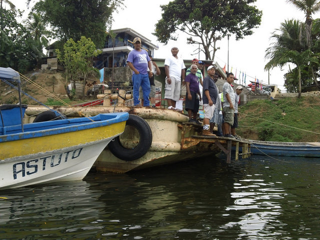 Fishermen and stevedores on one of the docks on the Punta Gorda River, near where it runs into the Caribbean Sea, the projected Caribbean extreme of the interoceanic canal, where local residents have not seen any visible sign of progress on the works officially launched more than two years ago. Credit: José Adán Silva/ IPS