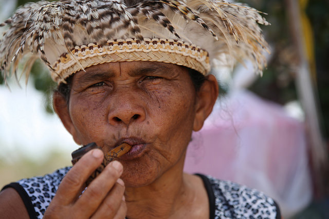 Dorinha Tuxá, a leader of the native Tuxá people, sings to her sacred river and smokes her "marakú", a pipe with tobacco and ritual herbs, to ask her ancestors to help them get the lands which were promised to them when they were evicted from their island to make way for a dam in northeastern Brazil. Credit: Gonzalo Gaudenzi / IPS