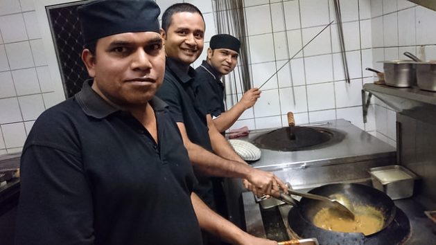 Julmat Khan [center] cooking with two other migrant chefs at his Little Indian restaurant in Broome, Western Australia. Credit: Neena Bhandari/IPS