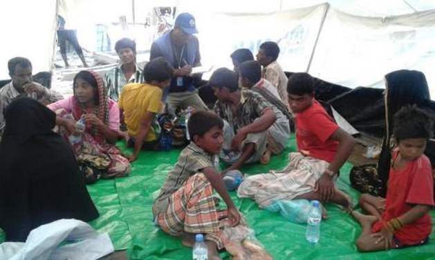 IOM staff speak to survivors from a fishing boat that capsized in stormy weather in waters between Bangladesh and Myanmar. Photo: UN Migration Agency (IOM) 2017
