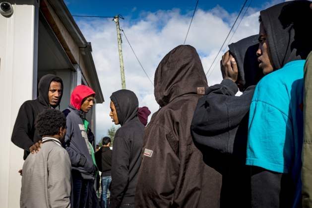 Unaccompanied children in the Calais migrant camp await interviews with the UK Home Office, October 22, 2016. © 2016 Zalamai/Human Rights Watch