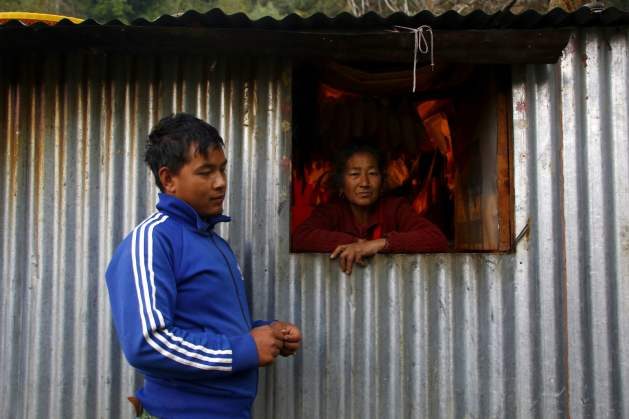 Rohan Tamang will soon leave for the Middle East. His mother Chameli Tamang says that the money he can earn there is needed for their house. Credit: Bikram Rai
