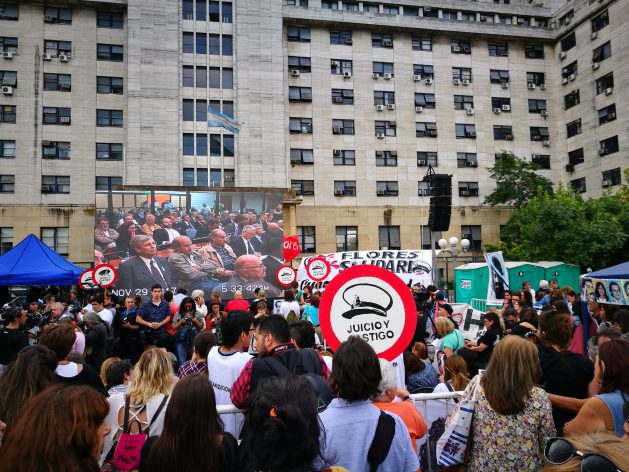 Outside the courtroom in the city of Buenos Aires, the relatives of victims of the dictatorship and human rights activists watched on a big screen the late November sentencing in the trial for the crimes committed during the de facto regime at the Navy School of Mechanics (ESMA). In the trial, which lasted five years, 29 people were sentenced to life imprisonment. Credit: Centre for Legal and Social Studies (CELS)
