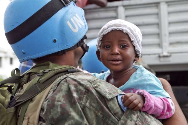 A UN peacekeeper holds a child as her mother is helped down from a relocation truck in Port-au-Prince, Haiti. Credit: UN Photo/Logan Abassi. The Oxfam scandal is an unfortunate blight. Organisations in similar circumstances must be transparent about how they punish culprits and what remedial and preventive actions they have taken. Justice must be unrelenting and exemplary, in pursuit of individuals who commit such acts, regardless of their rank or station. The guilty must go to jail in the country they commit such an offence.
