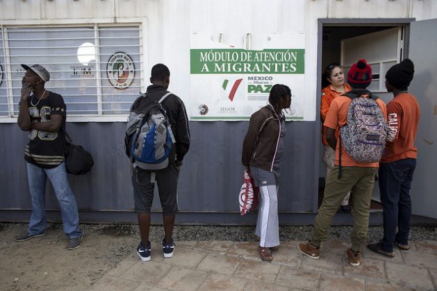 Haitian migrants seek information at the governmental National Migration Institute of Mexico, located next to the Chaparral port of entry, a busy Mexico-U.S. border crossing in the northwestern city of Tijuana. Credit: Guillermo Arias / IPS