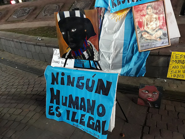 "No human being is illegal," reads a banner with the Argentine flag in the background in the Jun. 16 demonstration against police brutality towards Senegalese street vendors in front of the Obelisk in Buenos Aires. Almost no Senegalese immigrants participated, apparently for fear of police repression. Credit: Daniel Gutman/IPS