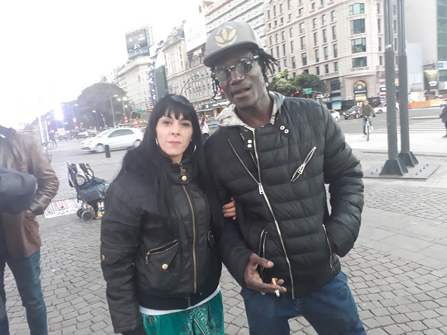 Moussa Sow, an immigrant who has been working as a street vendor in the Greater Buenos Aires area for 12 years, is photographed with his Argentine wife, Aldana Paviolo. Sow says that until recently he had a good relationship with the police in the Argentine capital, but that now he has been a victim of police brutality. Credit: Daniel Gutman/IPS