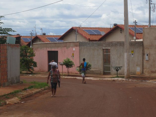 A view of houses with solar panels on their rooftops in the Maria Pires Perillo housing complex, two kilometres from the city of Palmeiras de Goiás. With 740 homes, it is the largest solar energy project in social housing complexes in the state of Goiás, in central Brazil. Credit: Mario Osava/IPS