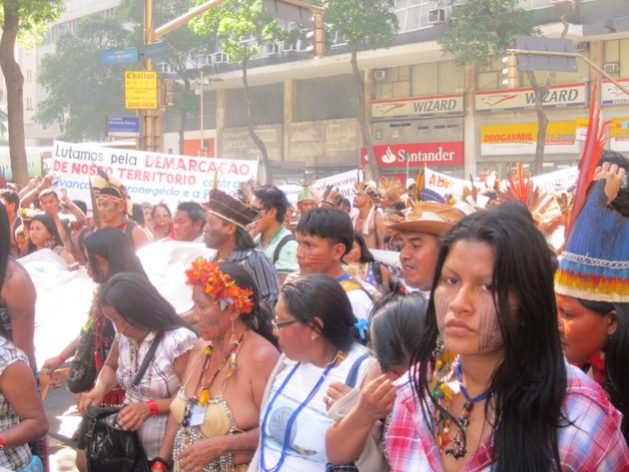 "We are fighting for the demarcation of our territory," reads a banner in a march of indigenous women who came to Rio de Janeiro from the communities of the 305 native peoples of Brazil, to demand respect for the rights recognised by the constitution, which far-right President Jair Bolsonaro began to ignore as soon as he was sworn in. Credit: Mario Osava/IPS