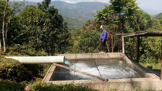 A man shows the 27-cubic-meter tank of the La Taña community hydropower system, one of four installed in this remote mountainous region populated mostly by indigenous people in the northwestern department of Quiché, Guatemala. Credit: Edgardo Ayala/IPS