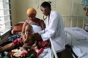 An eight-month-old boy is examined by a doctor in Dar es Salaam, Tanzania. Credit: Kristin Palitza/IPS