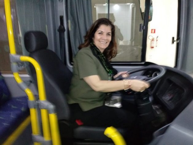 Iêda de Oliveira sits at the wheel of one of the buses manufactured by the company she heads, Eletra, a pioneer in electric and hybrid buses in Brazil. She regrets that Brazil, due to a lack of adequate public policies, has lost the foreign market for buses and part of the domestic market to China, after having been a major exporter of buses to Latin America and other regions. CREDIT: Courtesy of Eletra