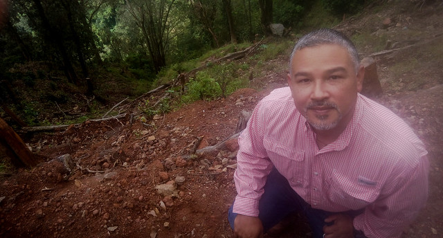 Héctor Velásquez, owner of the Los Robles coffee farm on a slope of the San Salvador volcano, shows the effects of a landslide on his coffee plantation after Tropical Storm Amanda in May. With the support of the United Nations Environment Programme, he has implemented innovative prevention measures, such as the introduction of live and dead barriers. CREDIT: Edgardo Ayala/IPS