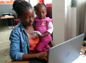 Marcia Julio Vilanculos, pictured here in this dated photo with her baby, was one of the participants of a digital literacy training course at Ideario innovation hub, Maputo, Mozambique a few years ago. Only 6.8 percent of all Mozambican women, with or without owning a cellphone, use the internet. Questions remain about the possibility of a successful transition to a digital economy in a world where there’s a glaring digital divide -- one that has become even more pronounced under the pandemic. Credit: Mercedes Sayagues/IPS
