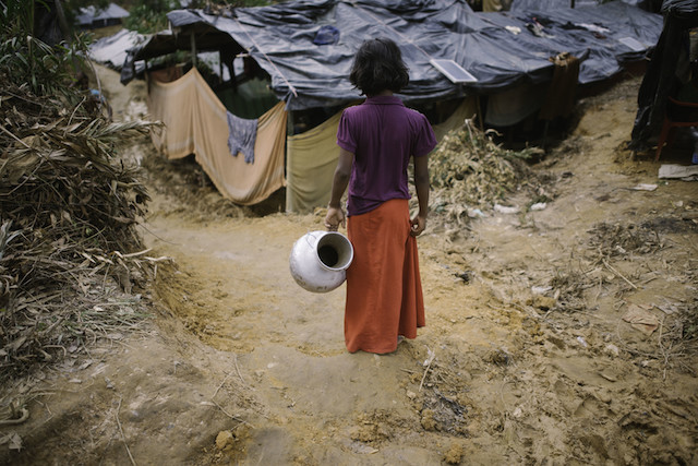 A Rohingya girl goes to fetch water in Cox’s Bazar, Bangladesh. A Mar. 22 fire spread through the camp, damaging important infrastructure including hospitals, learning centres, aid distribution points and a registration centre. While a few learning centres were burnt down, a number of them were not affected by the fire. (file photo)Credit: Umer Aiman Khan/IPS