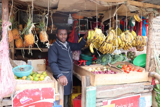 Joseph Lowasa Baraka at his vegetable and fruit kiosk in Nairobi. During Kenya’s coronavirus lockdowns traders opted to stay away from congested market places and prioritised more secure digital platforms. Credit: Isaiah Esipisu/IPS