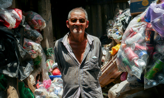 José Cruz Miranda, a resident of Los Cóbanos, a village on the Salvadoran coast, was a fisherman for more than 30 years, but had to stop due to health problems. Now he gathers empty cans, which he sells to a recycling company - environmental work that helps reduce pollution in an area with rich coral communities. CREDIT: Edgardo Ayala/IPS