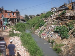 One of the favelas or shantytowns of São Paulo, Brazil's largest city, where local residents have turned a stream into an open-air garbage dump and a source of frequent flooding due to lack of sewage and garbage collection. Nor do favelas in Brazil’s cities have piped water. CREDIT: Mario Osava/IPS