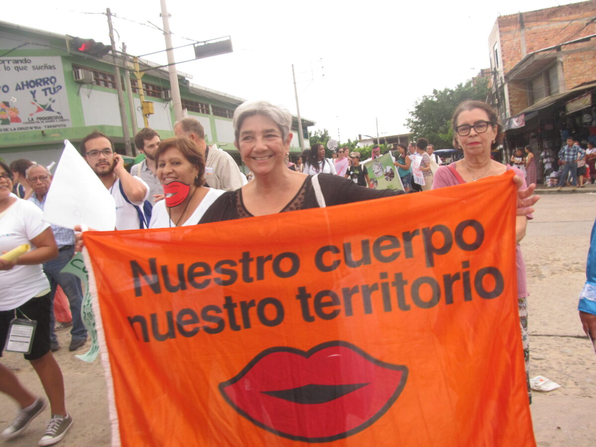 Uruguayan ecofeminist Lilian Celiberti carries a banner reading "Our body, our territory" in the streets of Tarapoto, a city in the central Peruvian jungle, during an edition of the Pan-Amazon Social Forum. CREDIT: Mariela Jara/IPS