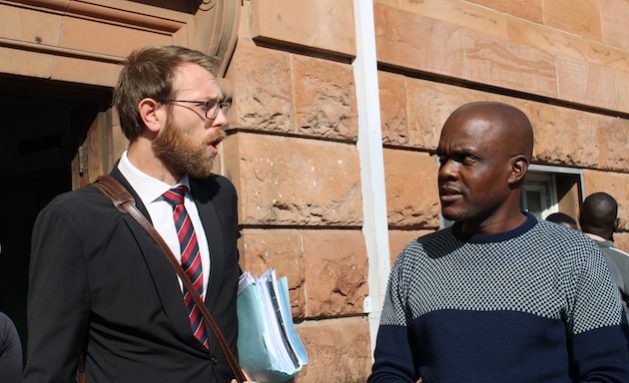 Journalist Jeffery Moyo, with his lawyer, Doug Coltart, outside the Magistrate’s Court, Bulawayo, Zimbabwe. Moyo faces charges of violating Section 36 of the Immigration Act. His sentencing is expected on May 31, 2022. Credit: Busani Bafana/IPS