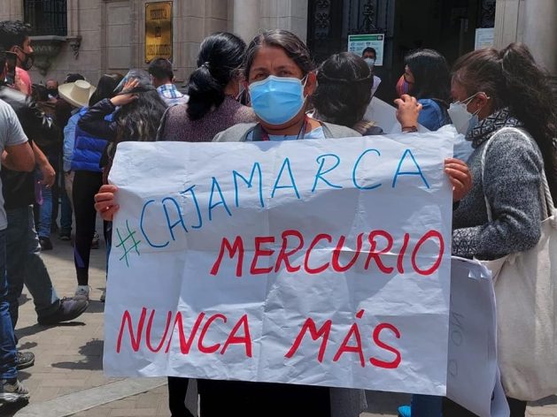 Juana Martínez takes part in an October 2021 protest in Lima organized by the platform of people affected by heavy metals in front of Congress, holding a sign that reads: "Cajamarca. Mercury Never Again". She was 29 years old when the mercury spill occurred in her town, Choropampa, in Peru’s northern Andes highlands. Several of her relatives have since died from the effects of the heavy metal and one of her sisters became sterile. CREDIT: Courtesy of Milagros Pérez