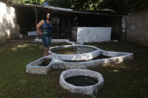 Farmer Mayra Rojas says that the Chinese-type fixed-dome biodigester built in back of her home in Carambola, in the municipality of Candelaria in western Cuba, has become part of her daily life and a key factor in improving her family's quality of life. CREDIT: Jorge Luis Baños/IPS