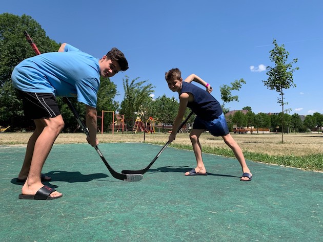 Artem and Maksim play hockey in Hungary. Credit: Katie Wilkes, International Federation of Red Cross and Red Crescent Societies
