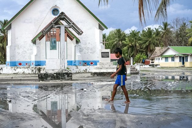 This photo was taken a month after Cyclone Pam hit Tuvalu. It shows the main square of Nui Island was still underwater. The tropical storm went onto Vanuatu, impacting nearly half the island's inhabitants. Credit: Silke von Brockhausen/UNDP