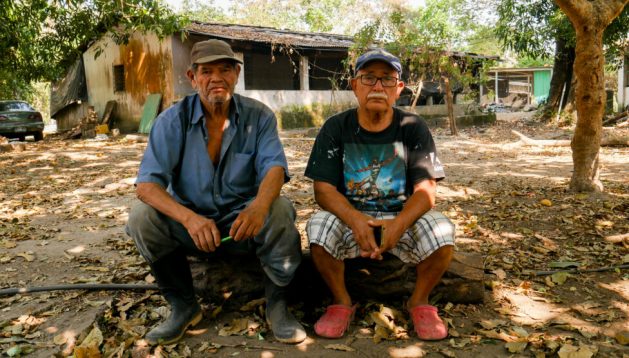 Martín Pineda (R) is in charge of a four-hectare community farm on the outskirts of San José Villanueva, in southern El Salvador. He says no government has focused on food sovereignty in the past 30 years. He and other farmers, like his co-worker Miguel Ángel García (L), complain that they lack technical support to produce food efficiently. CREDIT: Edgardo Ayala/IPS