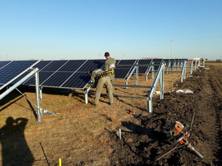 Two workers carry out maintenance tasks at the solar park in Monte Caseros, a town in the Argentine province of Corrientes, in the northeast of the country. The park was inaugurated in 2021 by the local cooperative, which provides electricity to the residents and is also involved in agricultural activity. CREDIT: Monte Caseros Agricultural and Electricity Cooperative