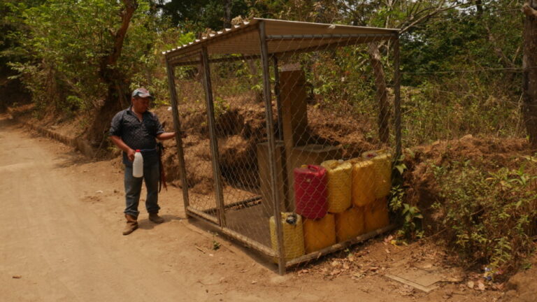 A farmer gets ready to fill a jug at one of the water taps located in the Jocote Dulce canton, in the eastern Salvadoran department of San Miguel, where water is always scarce. The community taps are padlocked, so that only people with permission can use them. CREDIT: Edgardo Ayala/IPS