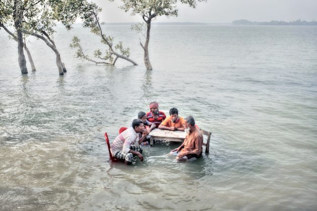 Gabura Union, situated in the southwestern region of Bangladesh near the Sundarbans Mangrove Forest, faces a dire threat as scientists predict that it could be submerged by the year 2025 due to the impacts of climate change. This area, characterized by low-lying coastal terrain, is exceptionally vulnerable to sea-level rise and storm surges. The rising sea levels, exacerbated by global warming, have already resulted in significant land erosion and the displacement of local communities. According to scientific studies and reports, including those from the Intergovernmental Panel on Climate Change (IPCC), the situation in Gabura Union is dire, and urgent measures are required to mitigate the impending crisis. Efforts to combat this issue include the construction of protective barriers and the promoting of climate-resilient practices, but the challenge remains substantial. The plight of the Gabura Union is a stark reminder of the profound and devastating impacts of climate change, particularly in coastal regions. It underscores the urgency of global efforts to mitigate its effects. Gabura, Satkhira, Bangladesh Credit: Mohammad Rakibul Hasan