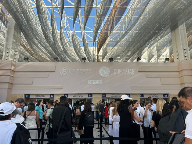 Workers, some from regions impacted by climate change, joined queues for accreditation outside Expo 2020 in Dubai, where COP28 is being held. Credit: Stella Paul/IPS
