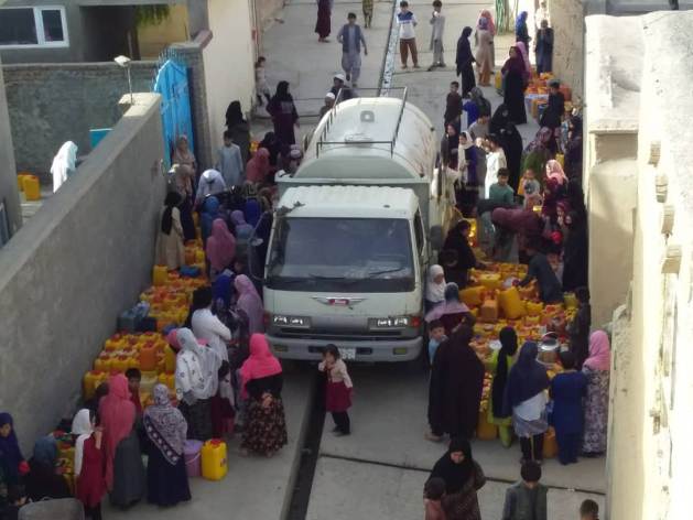 Women and children in Afghan cities endure hours-long queues for a vital resource—water. Credit: Learning Together