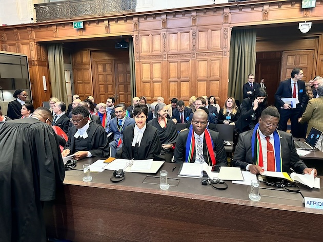 South African Justice Minister Ronald Lamola and Vusi Madonsela, Ambassador to the Netherlands, both wearing South African colours with the legal team at the International Court of Justice in the Hague. Credit: Chrispin Phiri/SA Ministry Justice and Correctional Services