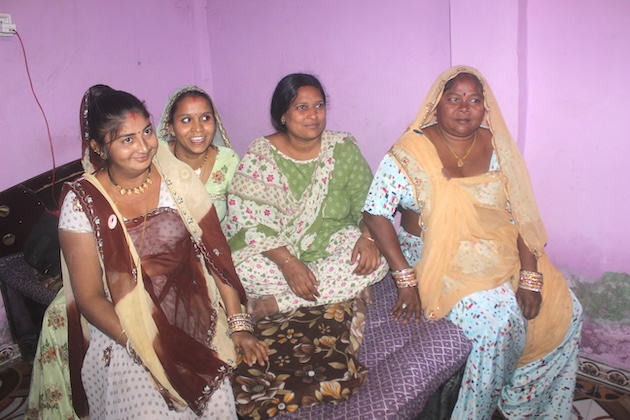 A regular visitor to Odni Chawl, Niruben Badoria, field organiser with Mahila Housing Trust (2nd from right), sits chatting with the women. Credit: Manipadma Jena/IPS 
