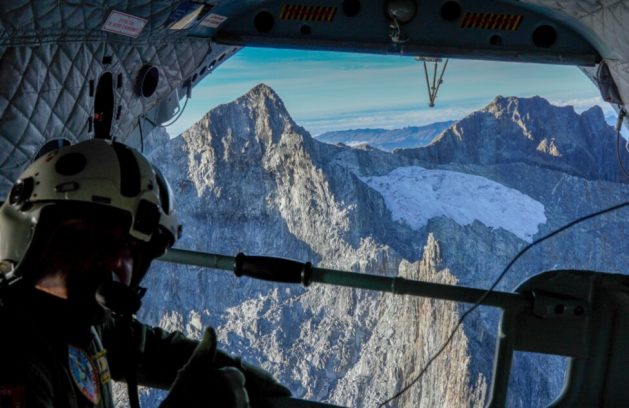 An armed forces helicopter flies over the area of La Corona, which will be covered by a plastic blanket, on the Humboldt Peak in the Andes. It is the last glacier in Venezuela and will possibly disappear in less than two years. CREDIT: Harrison Ruiz / Minec