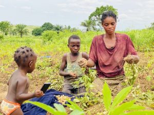 Agathe and her two children cleaning the harvest of groundnuts produced from her 3 hectare plot. Credit: SADC-GMI - “My story is exemplary of the challenges faced by numerous women farmers: I lack ownership of the land I farm, have no direct access to markets to sell my produce, and endure the absence of reliable transportation means”
