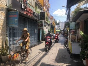 One of many small streets in Ho Chi Minh City, with newly-build towers in the background. Credit: Kris Janssens / IPS