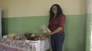 Leide Aparecida Souza, president of the Association of Residents of the Genipapo Settlement in the rural area of Acreúna, a municipality in central-western Brazil, stands next to breads and pastries from the bakery where 14 rural women work. The women's empowerment and self-esteem have been boosted by the fact that they earn their own income, which is more stable than from farming, and provide an important service to their community. CREDIT: Marina Carolina / IPS