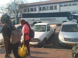 Migrants use a cross-border bus in Bulawayo to enter South Africa. Credit: Ignatius Banda/IPS