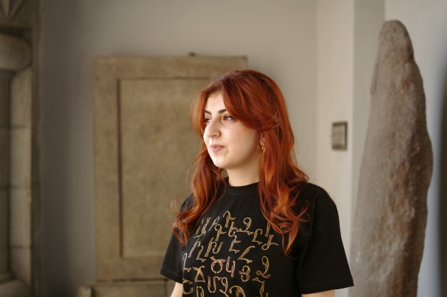Snezhana Tamrazyan, a 22-year-old displaced woman from Nagorno-Karabakh, at the Institute of Ancient Manuscripts in Yerevan. Karabakh people are forced to seek refuge in a country plagued by economic and political crises. Credit: Narine Karapetyan/IPS.