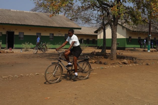 Faith Machavi pedals a bicycle at Mwenje Dumisani Secondary, Chiredzi, in Zimbabwe. Credit: Farai Shawn Matiashe/IPS
