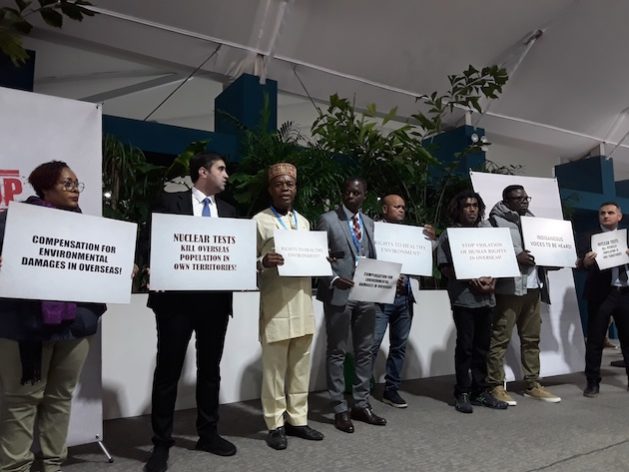 Delegates representing Indigenous communities urge negotiators to include language that promotes human and environmental rights. Credit: Joyce Chimbi/IPS