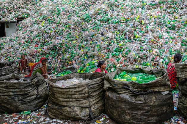 Female workers sort out plastic bottles for recycling in a factory in Dhaka, Bangladesh. Credit: Abir Abdullah/Climate Visuals Countdown