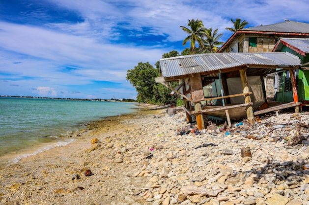 A house damaged due to coastal erosion caused by rising sea levels in Tuvalu. Credit: Joseph Hing/Pacific Community