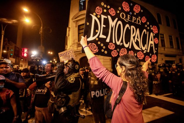 A protester holding a sign declaring the death of democracy during social protests against the authoritarian policies of Peru's President Dina Boluarte in downtown Lima, July 2024. Credit: Walter Hupiu / IPS
