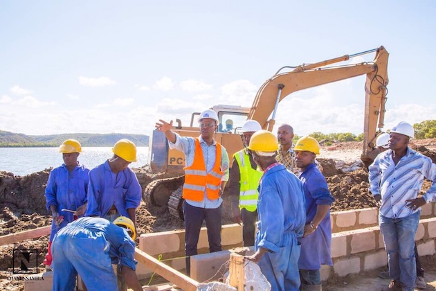 Construction workers in Pangani busy building a seawall to protect against encroaching seawater. Credit: Kizito Makoye/IPS