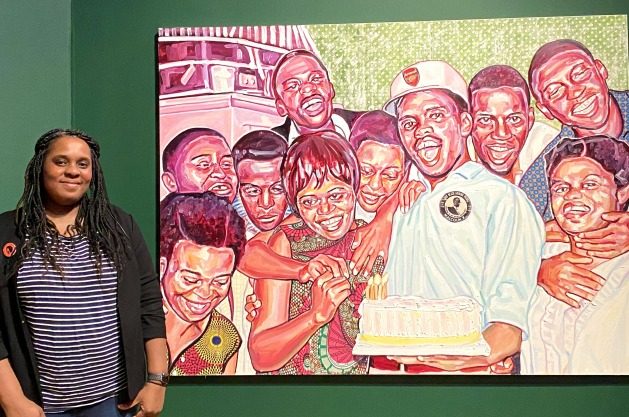 Esiri Erheriene-Essi and her painting The Birthday Party. Photo credit: AM/SWAN - When We See Us is a vibrant exhibition showcasing bold colors, dynamic compositions, and rhythmic energy. it offers a psychedelic journey through Black artistic history